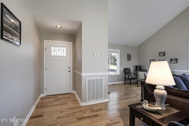 entrance foyer with visible vents, light wood-style flooring, and baseboards