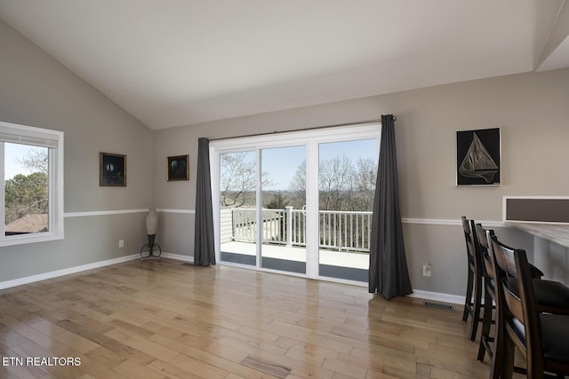 unfurnished dining area with visible vents, a wealth of natural light, and light wood-type flooring