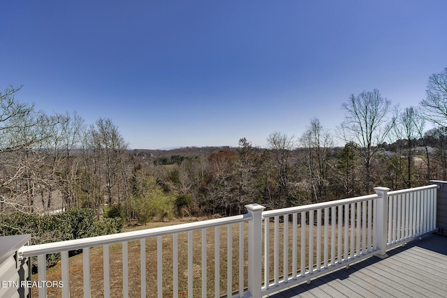 wooden terrace with a forest view