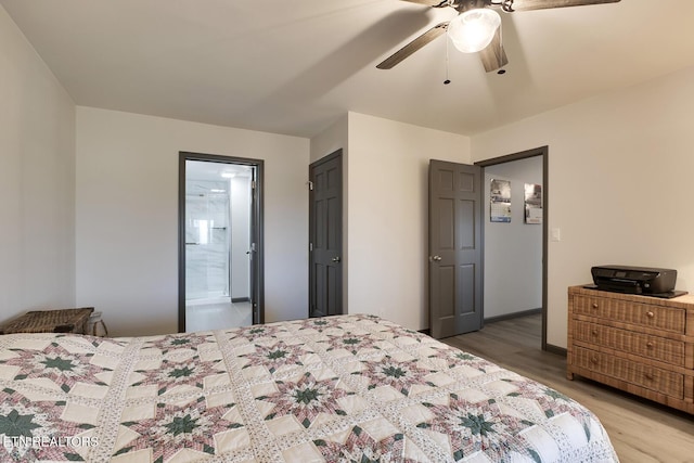 bedroom with connected bathroom, baseboards, light wood-type flooring, and ceiling fan