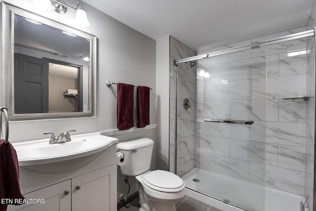 bathroom featuring visible vents, toilet, a stall shower, and vanity