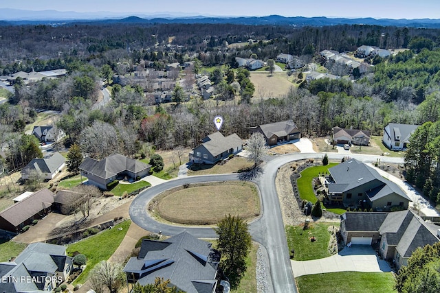 birds eye view of property featuring a residential view, a mountain view, and a forest view