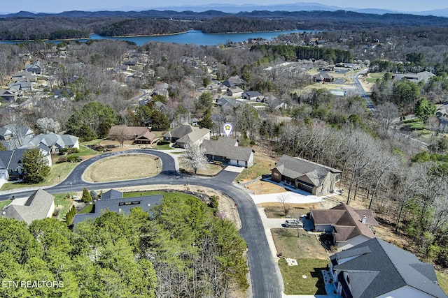 birds eye view of property featuring a residential view, a forest view, and a water view