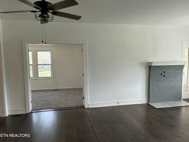 unfurnished living room with wood finished floors, baseboards, and ceiling fan