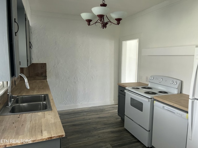 kitchen with ornamental molding, white appliances, a textured wall, and a sink