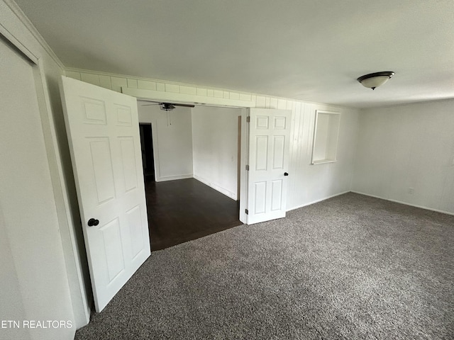 empty room with dark colored carpet