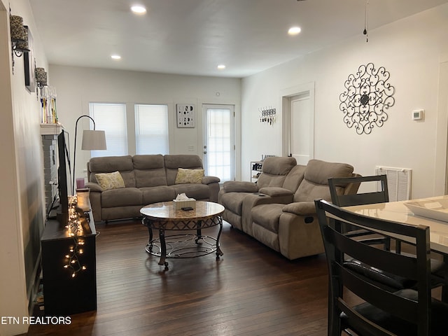 living room with dark wood finished floors, visible vents, and recessed lighting