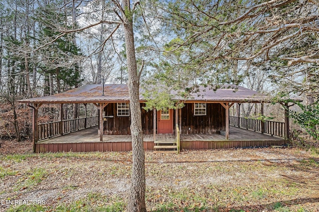 rear view of property with metal roof