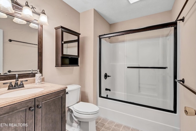 full bathroom with enclosed tub / shower combo, tile patterned floors, toilet, and vanity