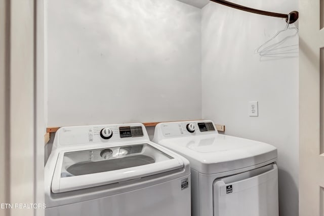 clothes washing area featuring laundry area and washing machine and clothes dryer