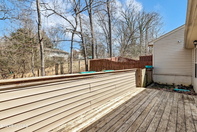 wooden terrace featuring fence