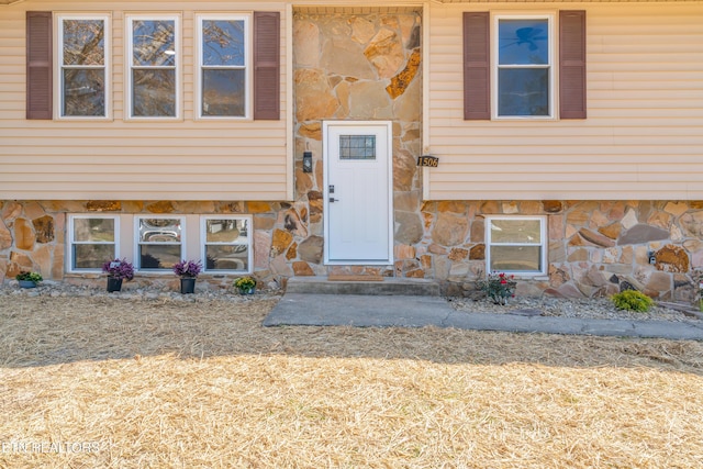 view of exterior entry featuring stone siding