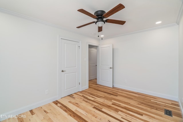 unfurnished room featuring baseboards, wood finished floors, ornamental molding, and a ceiling fan