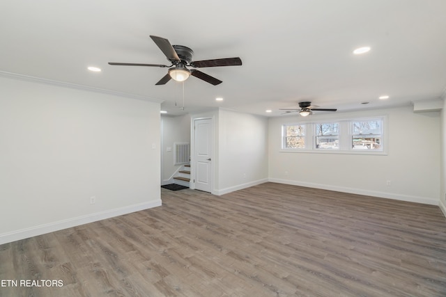 unfurnished living room featuring visible vents, baseboards, ceiling fan, and crown molding