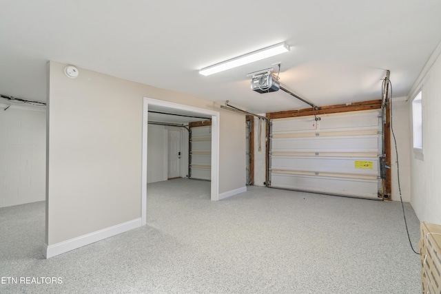 garage with concrete block wall and a garage door opener