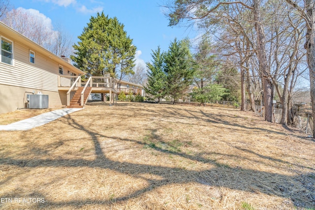 view of yard featuring cooling unit, stairs, a deck, and fence