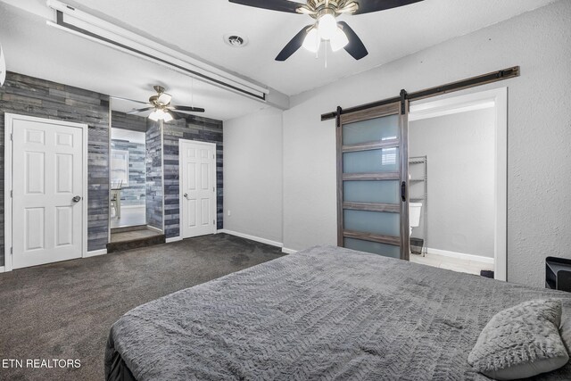 bedroom with a barn door, baseboards, carpet, and visible vents