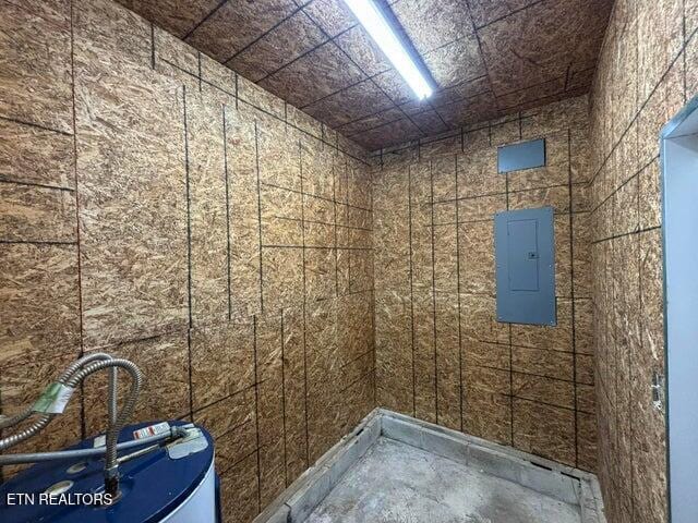 bathroom featuring electric panel and unfinished concrete flooring