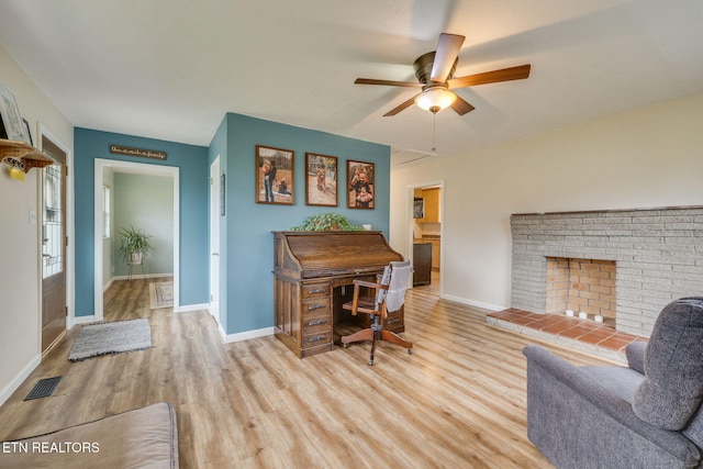 home office featuring baseboards, ceiling fan, visible vents, and wood finished floors