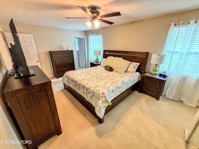 bedroom with light carpet and ceiling fan