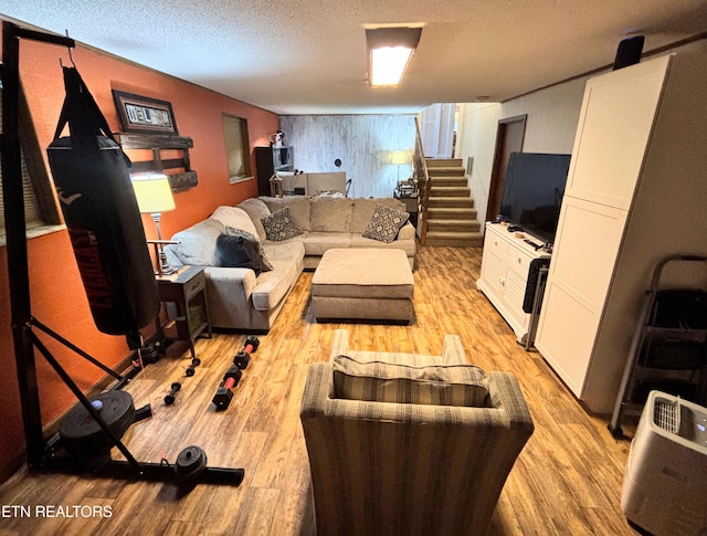 living room featuring light wood-style floors and a textured ceiling