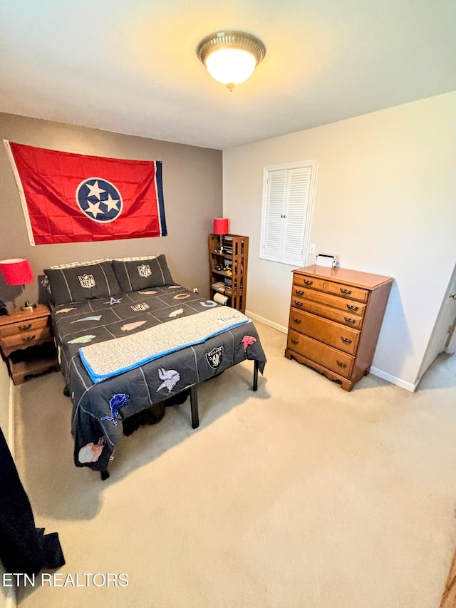 carpeted bedroom featuring baseboards