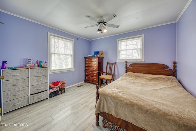 bedroom with visible vents, crown molding, ceiling fan, and wood finished floors