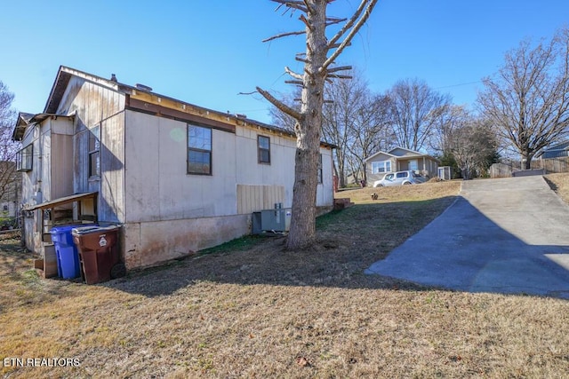 view of property exterior with a lawn