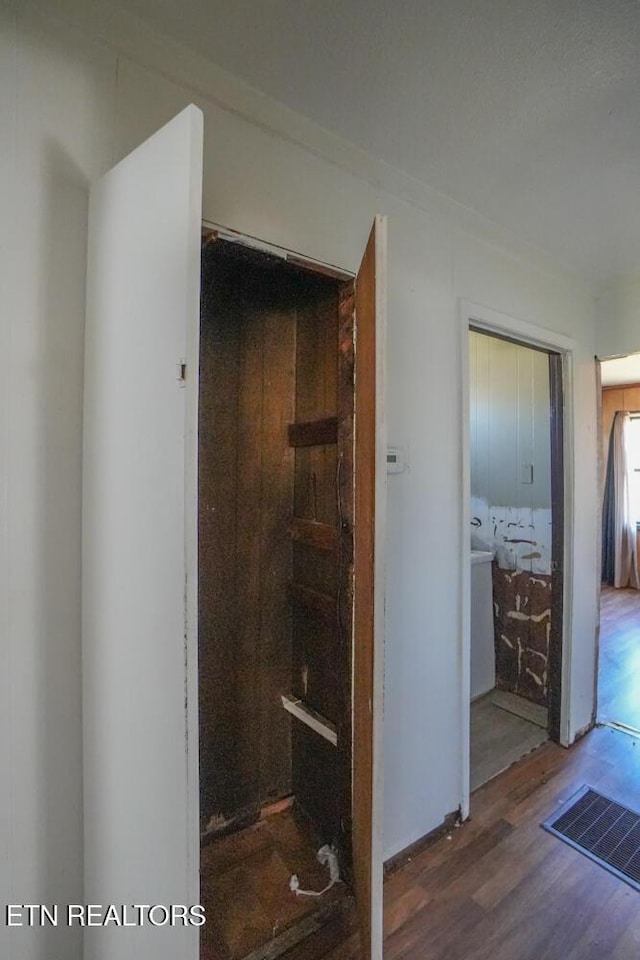 interior space with wood finished floors and visible vents