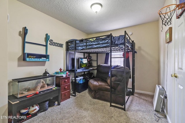 bedroom with a textured ceiling, baseboards, and carpet floors