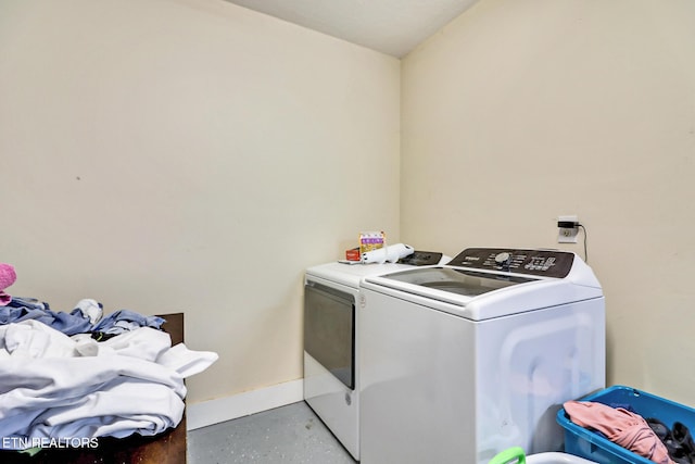 laundry area featuring washer and dryer, laundry area, and baseboards