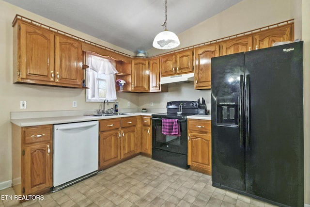 kitchen with a sink, black appliances, vaulted ceiling, under cabinet range hood, and brown cabinets