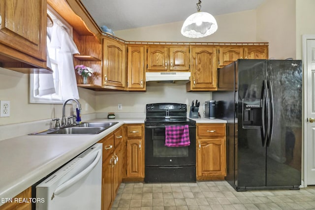 kitchen with under cabinet range hood, lofted ceiling, brown cabinetry, black appliances, and a sink