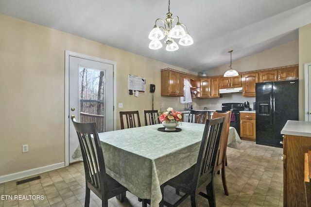 dining room with visible vents, baseboards, a chandelier, lofted ceiling, and light tile patterned floors