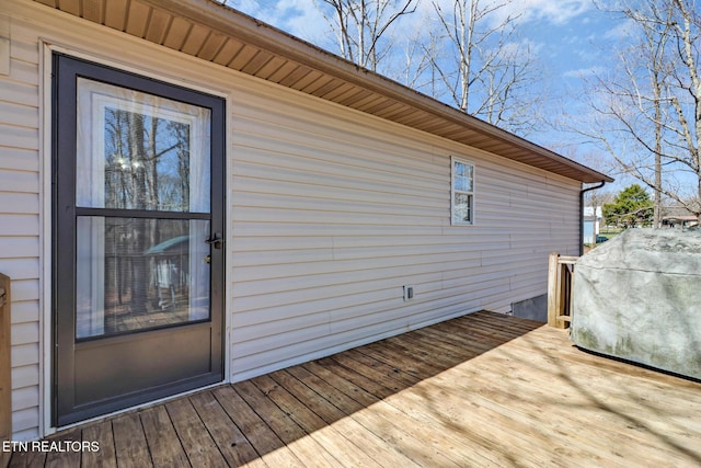 wooden deck featuring a grill