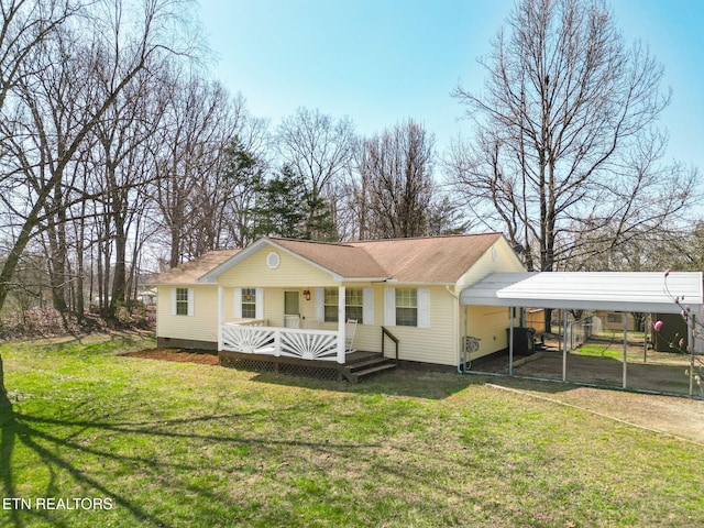 view of front of house featuring a front lawn, covered porch, roof with shingles, crawl space, and a carport