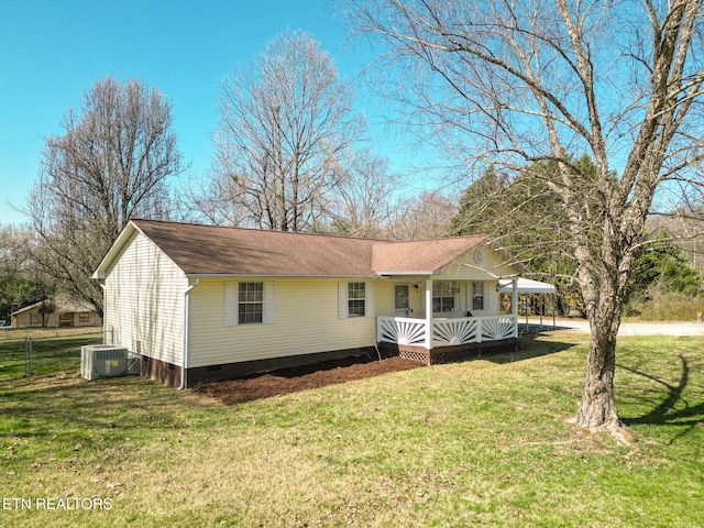 view of front of property with fence, central air condition unit, roof with shingles, a front yard, and crawl space