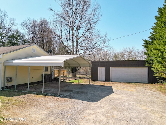 view of vehicle parking with fence and dirt driveway