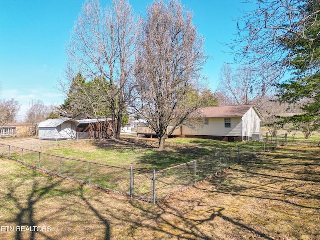 view of yard with an outbuilding, an outdoor structure, and fence