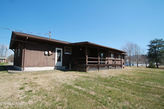 rear view of property with a yard