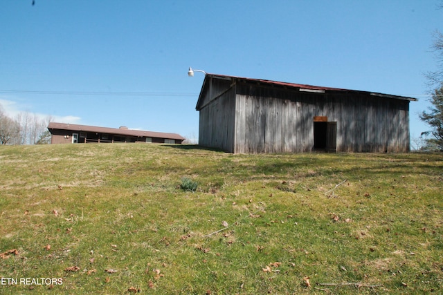 view of pole building with a yard