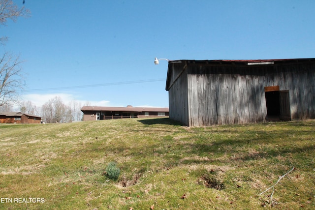 view of pole building with a lawn