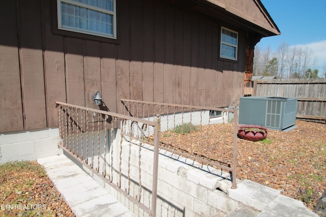 view of home's exterior featuring central AC and fence