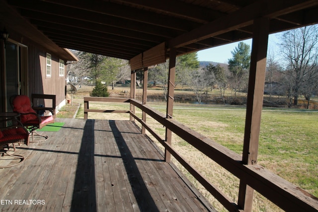 wooden deck with a lawn