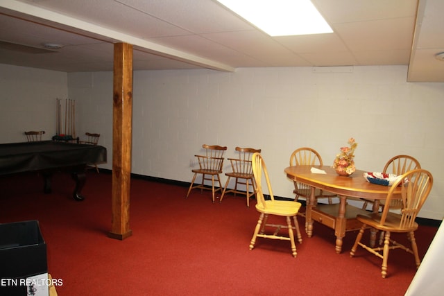 dining room featuring concrete block wall