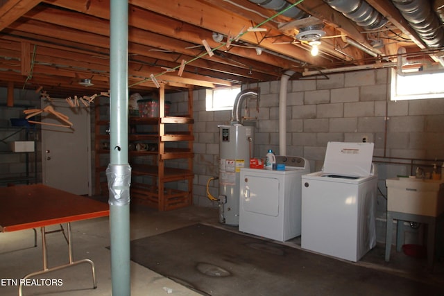 below grade area with water heater, washer and clothes dryer, and a sink