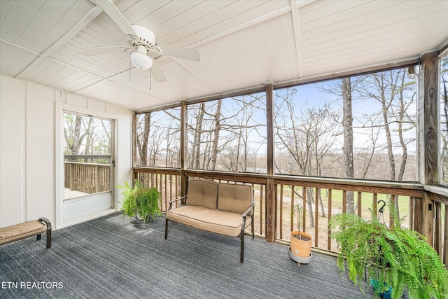 unfurnished sunroom with ceiling fan