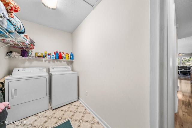 laundry room featuring laundry area, washer and dryer, and baseboards