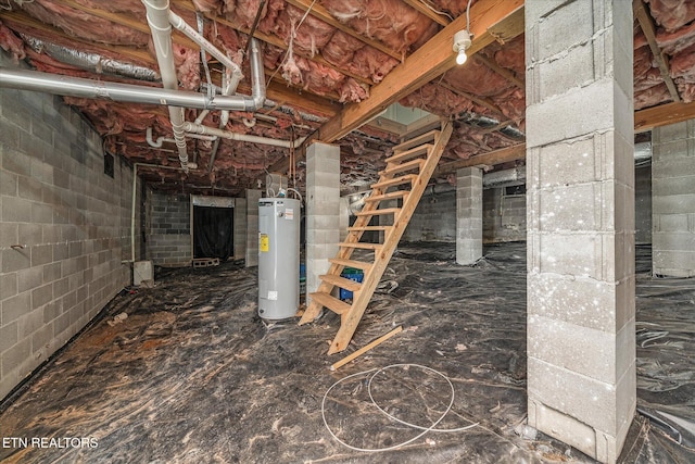 unfinished basement featuring electric water heater