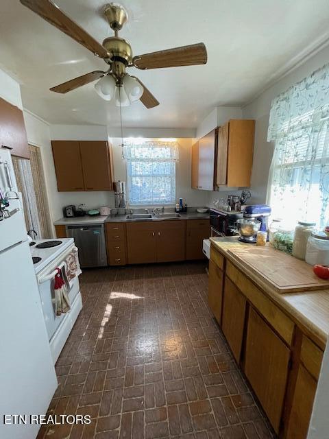 kitchen featuring brick patterned floor, a sink, white appliances, light countertops, and ceiling fan